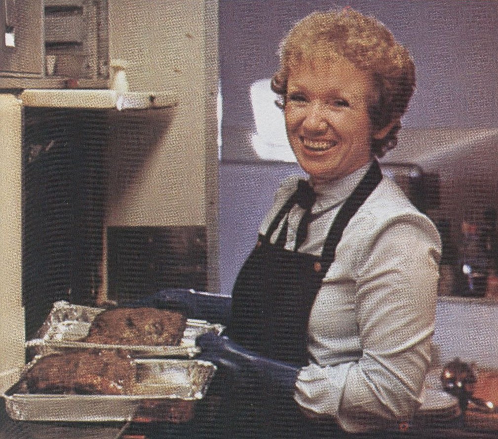 1980s On each long haul flight Pan Am assigned one flight attendant to work in the First Class galley to over see the preparation of the many courses offered.  These crew members were affectionately known as 'galley girls.'  Here a 'galley girl' prepares the beef roast in the First Class galley of a Lockheed L1011-500.